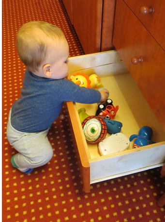 Baby playing in drawer