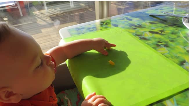 Baby eating off a mat