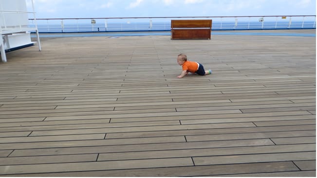 Infant crawling on cruise deck