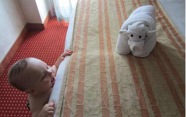 Baby on edge of a bed
