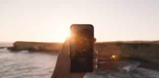 6 Simple Ways to Stay Connected With Others on a Cruise Ship Cell phone with waves