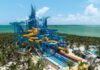 NCL’s 19-Slide Waterpark Debut in Less Than a Month (See the First Photos) Great Tides Waterpark tower with multiple slides coming off of it.