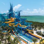 NCL’s 19-Slide Waterpark Debuts in Less Than a Month (See the First Photos) Great Tides Waterpark tower with multiple slides coming off of it.