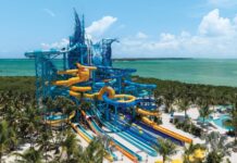 NCL’s 19-Slide Waterpark Debuts in Less Than a Month (See the First Photos) Great Tides Waterpark tower with multiple slides coming off of it.