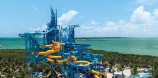 NCL’s 19-Slide Waterpark Debut in Less Than a Month (See the First Photos) Great Tides Waterpark tower with multiple slides coming off of it.