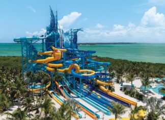 NCL’s 19-Slide Waterpark Debut in Less Than a Month (See the First Photos) Great Tides Waterpark tower with multiple slides coming off of it.