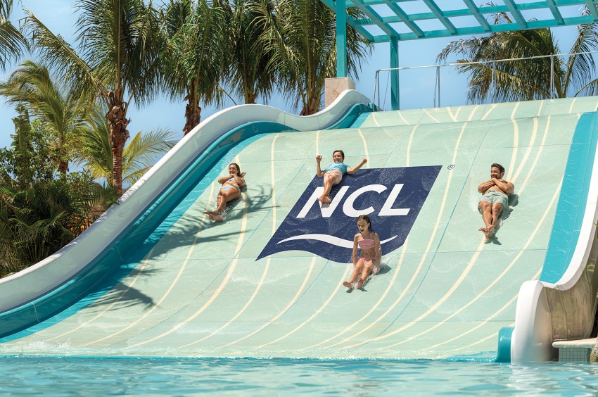Four people going down a waterslide