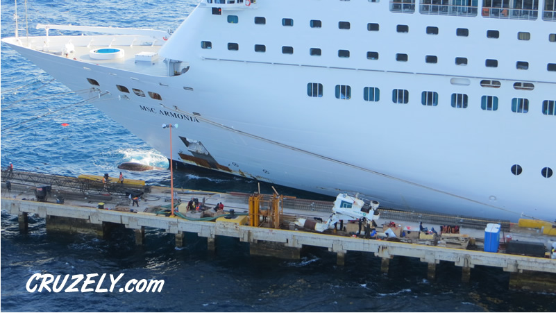 Damage to the hull of MSC Armonia from collision with pier in Roatan