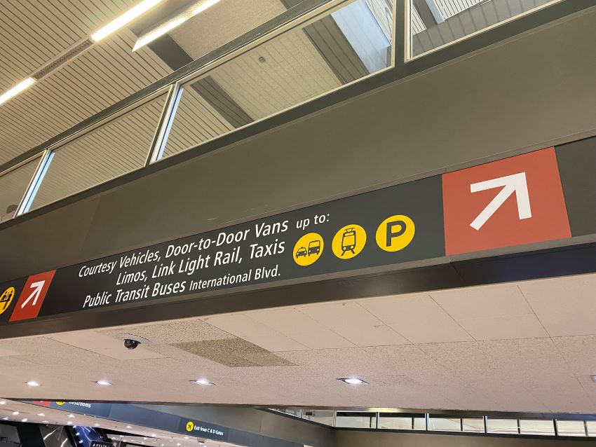 Sign showing different modes of transportation from the airport.