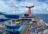 Carnival Quietly Makes a Drink Package Change That Means Longer Wait Between Servings Carnival Conquest pool deck with a blue sky