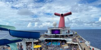 Carnival Quietly Makes a Drink Package Change That Means Longer Wait Between Servings Carnival Conquest pool deck with a blue sky