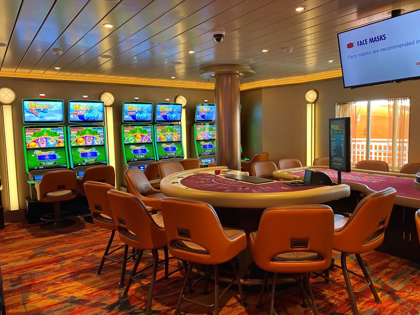 Cruise ship casino with slot machines and table game.