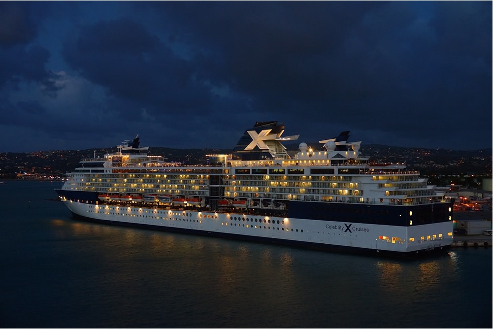 Celebrity ship sailing at night.
