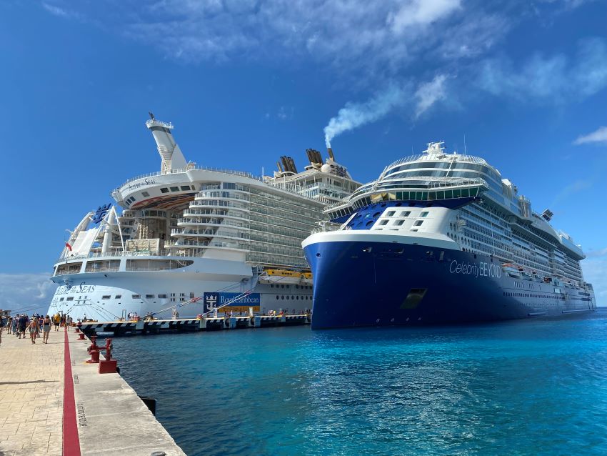 Royal Caribbean and Celebrity cruise ships docked next to each other.