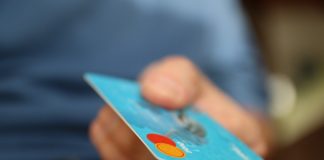 Everything to Know About Using Credit Cards on a Cruise Credit card in hand