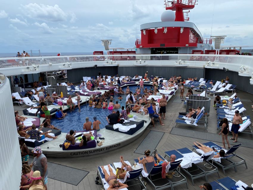 A crowded pool on a Virgin Voyages cruise ship