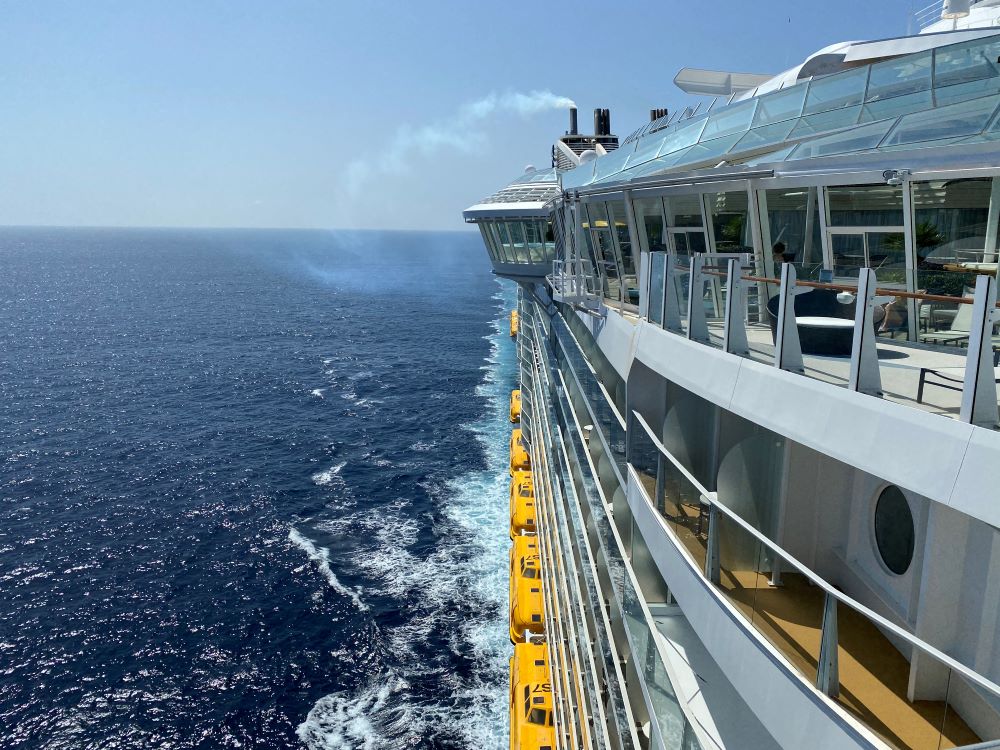 Side view of a ship sailing in the sun.