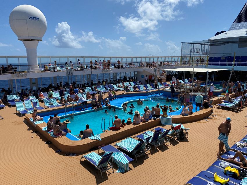 Cruise passengers on a busy pool deck