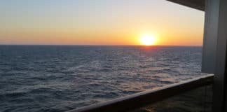 Why Dirt-Cheap Cruise Deals Could Be a Thing of the Past Sunset on cruise balcony