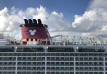 Disney Suspends Cruises. Will Other Lines Follow Suit? Disney cruise ship in port in Nassau