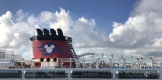 Disney Suspends Cruises. Will Other Lines Follow Suit? Disney cruise ship in port in Nassau