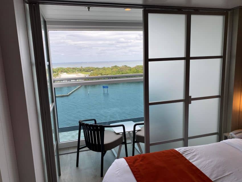 An infinite balcony room with one door closed.