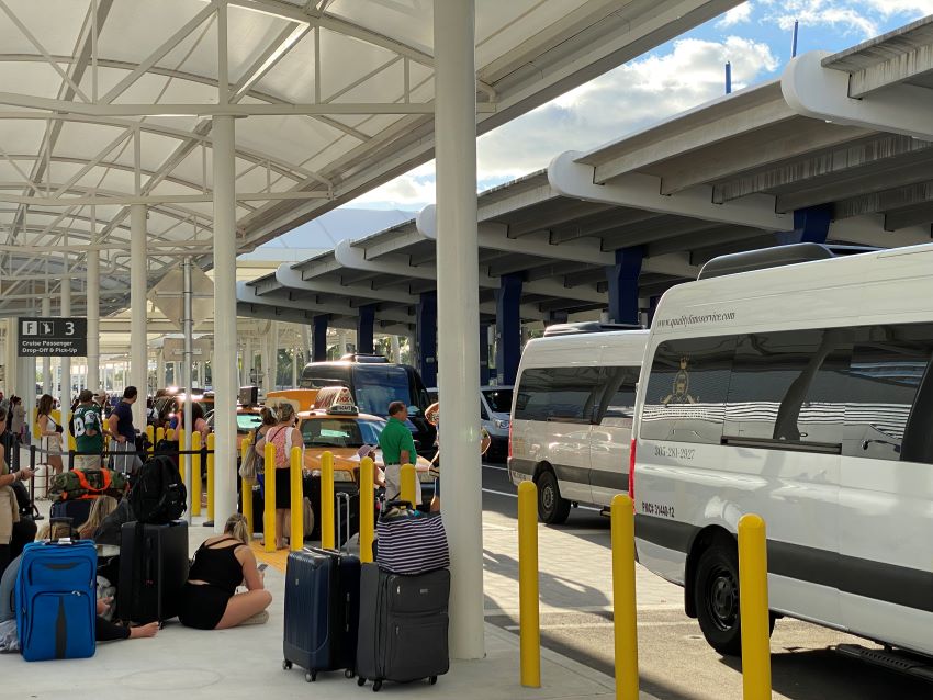 Taxis and shuttles picking up at a cruise terminal in Miami.