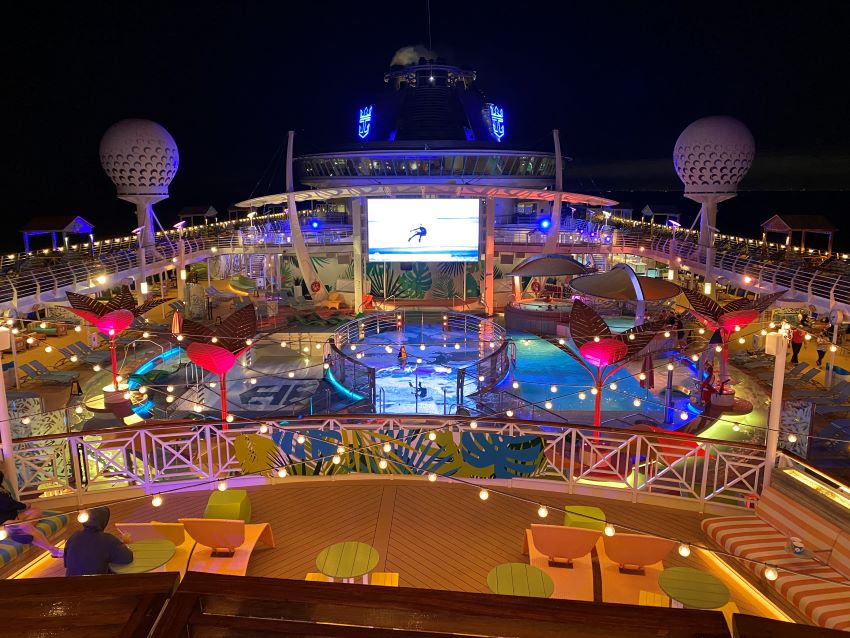Ship's deck at night with movie showing