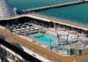 Staying on a Cruise Ship in Port: What to Know Before You Stay An empty pool deck while a ship is docked in port.