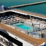Staying on a Cruise Ship in Port: What to Know Before You Stay An empty pool deck while a ship is docked in port.