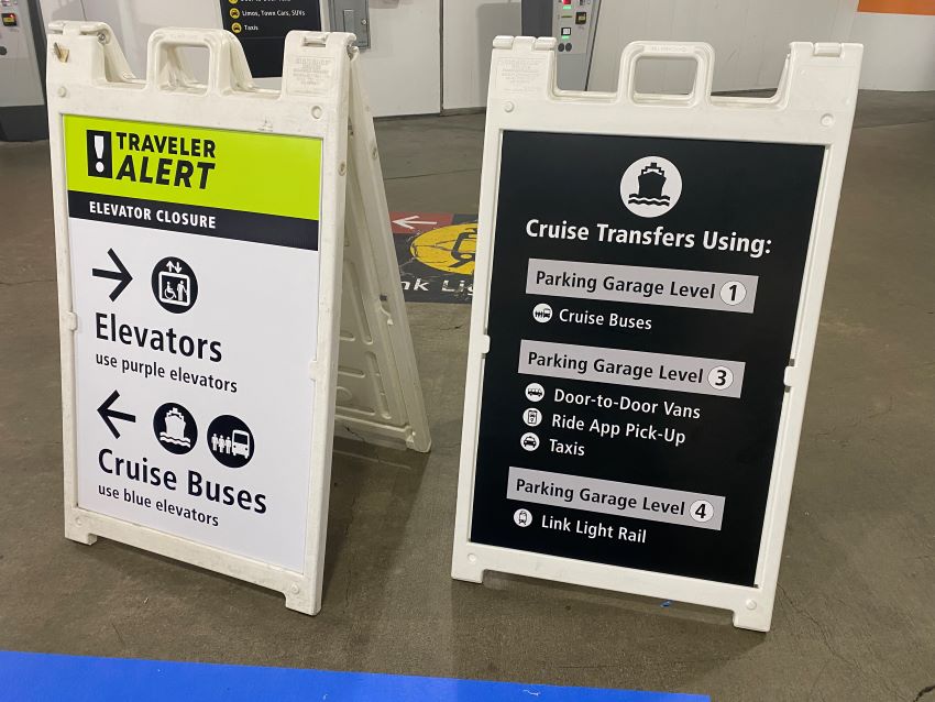 Sandwich board showing Seattle cruise transportation options.