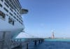 15 Must-Know Things About Ports of Call on a Cruise Ship in port of call with lighthouse in the distance