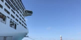 15 Must-Know Things About Visiting Ports of Call on a Cruise Ship in port of call with lighthouse in the distance