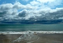 12 Tips & Things to Know About Buying Cruise Travel Insurance Stormy beach and sea