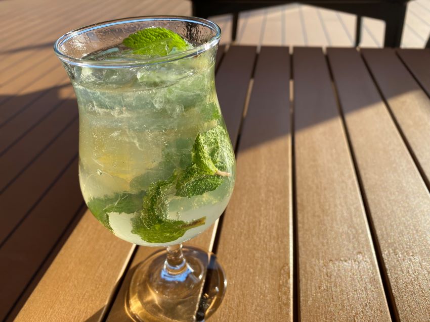 A mojito drink on a cruise sitting in sunshine